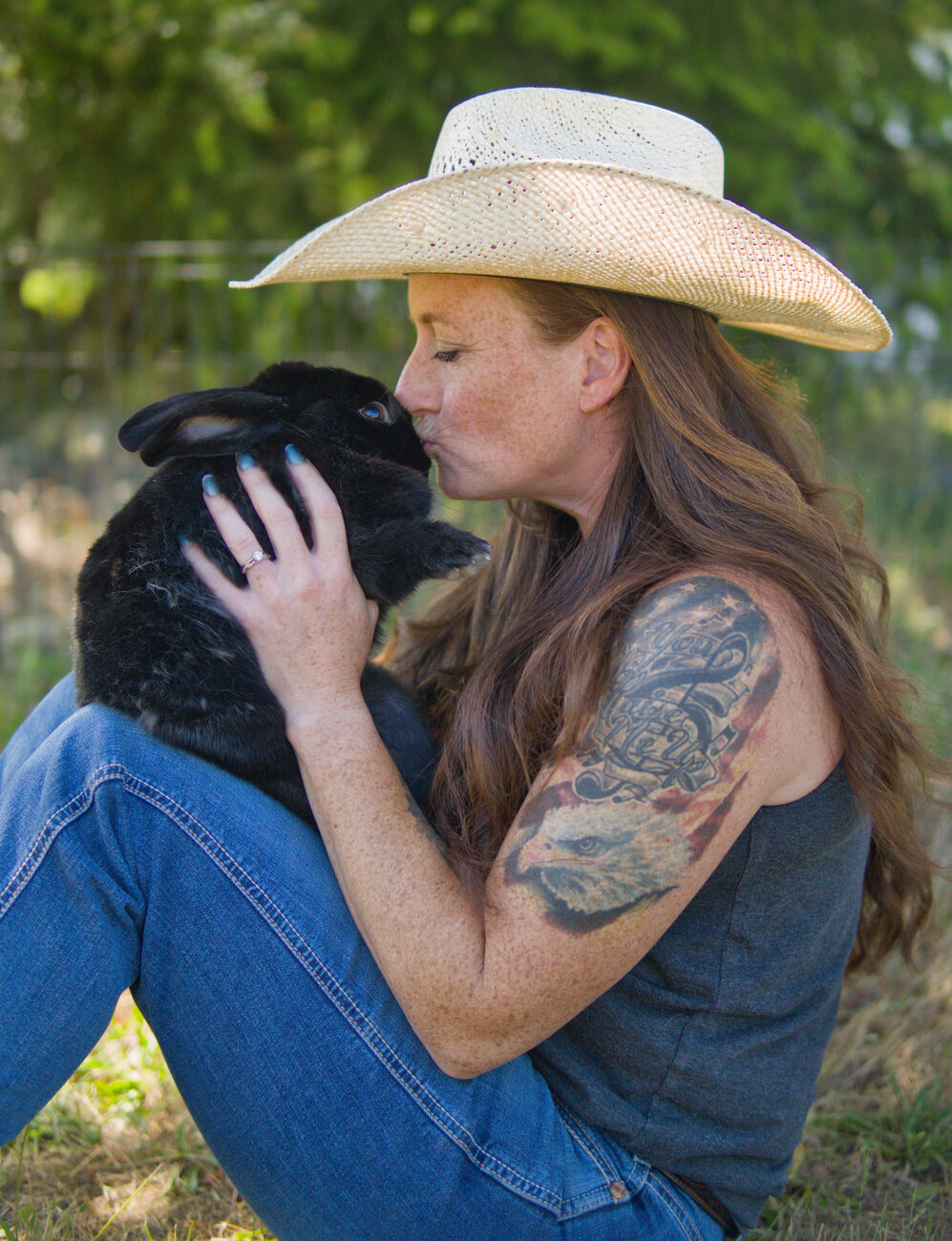Founder giving a black rabbit a gentle kiss