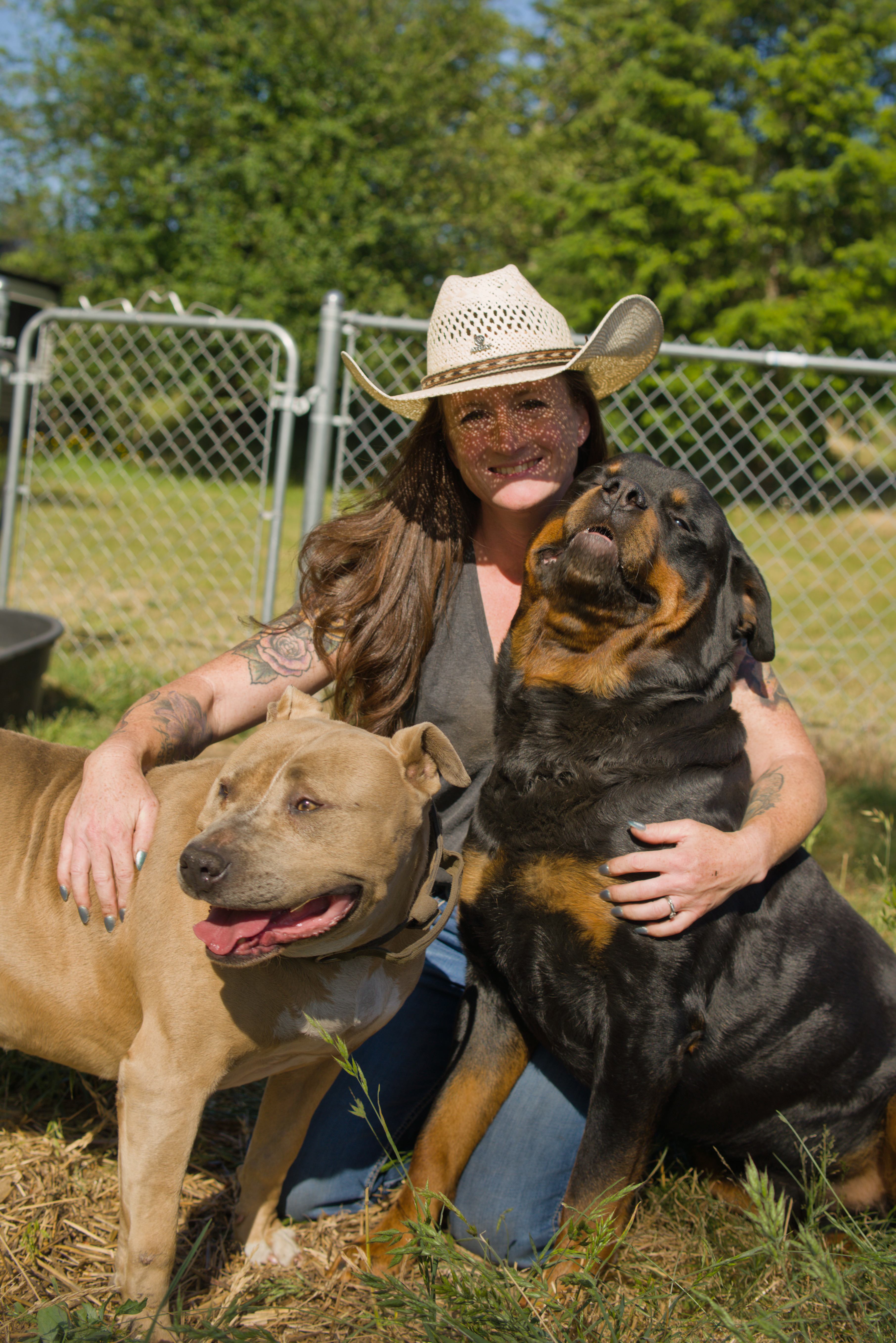 Susan, founder of Stand Down Sanctuary and Farm, smiling among her horses